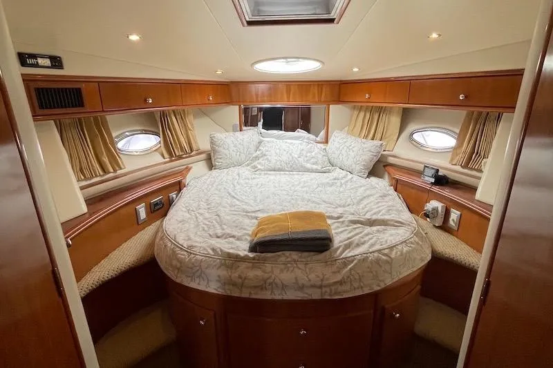 Four Us Yacht Photos Pics Luxurious cabin interior of 2006 Carver 42 Super Sport yacht with cozy bedding.