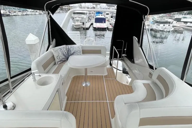 Four Us Yacht Photos Pics Luxurious 2006 Carver 42 Super Sport yacht interior with elegant seating and table.