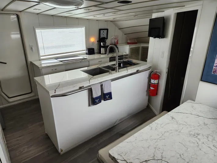 Pier Pressure Yacht Photos Pics Modern kitchen interior on 1990 Inace 88 Custom yacht with marble countertops.
