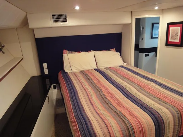 Pier Pressure Yacht Photos Pics Cozy bedroom in 1990 Inace 88 Custom yacht with striped bedding.