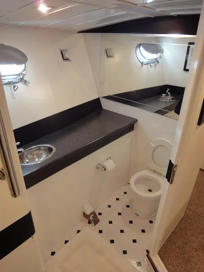 Pier Pressure Yacht Photos Pics Luxurious bathroom in 1990 Inace 88 Custom yacht with modern fixtures and porthole windows.