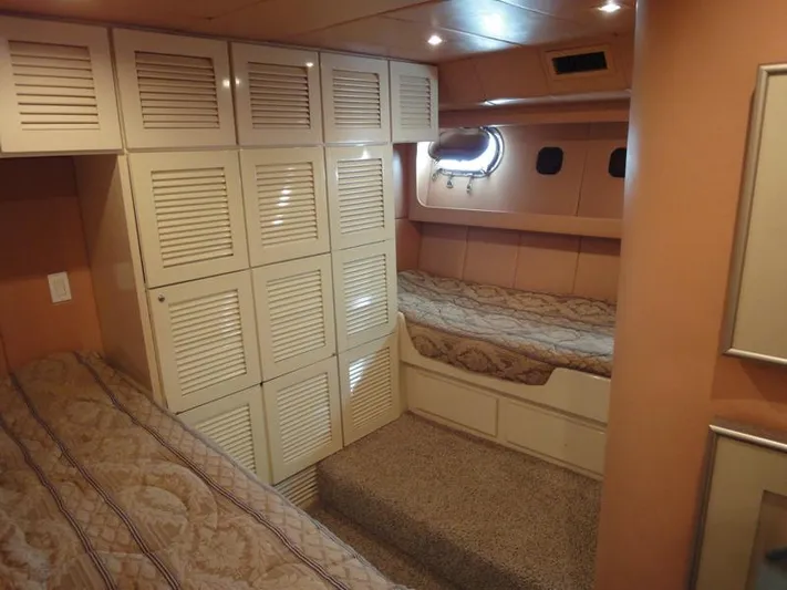Pier Pressure Yacht Photos Pics Cozy cabin interior of 1990 Inace 88 Custom yacht with twin beds and storage.