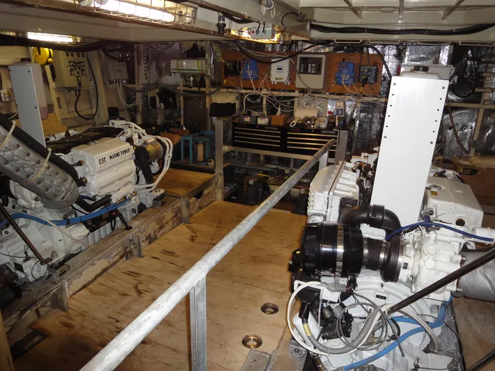 Pier Pressure Yacht Photos Pics Engine room of 1990 Inace 88 Custom yacht with visible machinery and equipment.