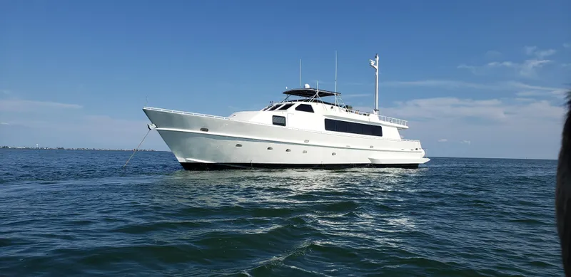 Pier Pressure Yacht Photos Pics White 1990 Inace 88 Custom yacht anchored on calm ocean waters under clear blue sky.