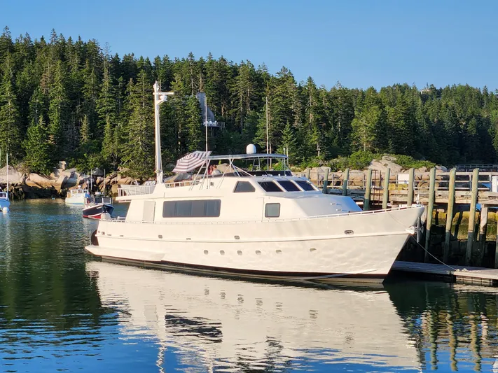 Pier Pressure Yacht Photos Pics Inace 88 Custom 1990 yacht docked in a serene forested harbor.