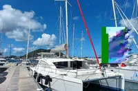 2018 Leopard 48 catamaran docked at marina under clear blue sky.