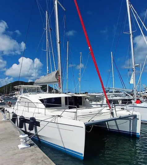 Andiamo IV Yacht Photos Pics 2018 Leopard 48 catamaran docked in a sunny marina, featuring sleek design and spacious deck.
