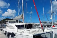 2018 Leopard 48 catamaran docked in a sunny marina, featuring sleek design and spacious deck.