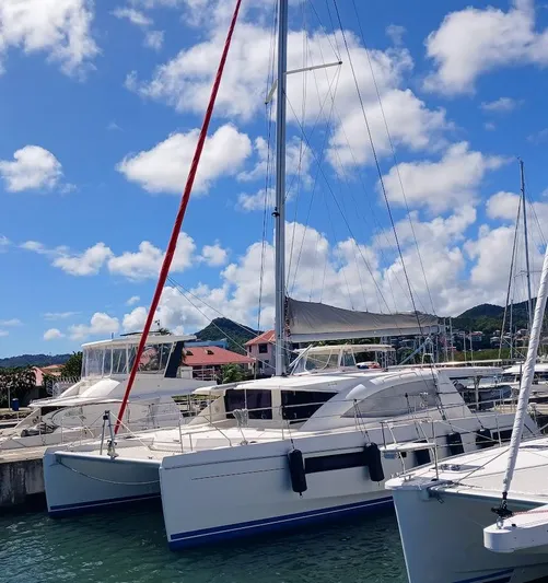Andiamo IV Yacht Photos Pics 2018 Leopard 48 catamaran docked at marina under blue sky.