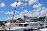 2018 Leopard 48 catamaran docked at marina under blue sky.