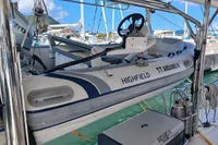 Inflatable boat on Leopard 48 yacht, 2018 model, docked at marina with clear skies.