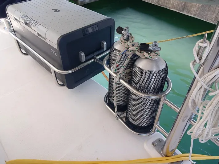 Andiamo IV Yacht Photos Pics Diving tanks and cooler on Leopard 48 yacht deck, 2018 model, near water.
