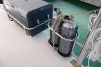 Diving tanks and cooler on Leopard 48 yacht deck, 2018 model, near water.