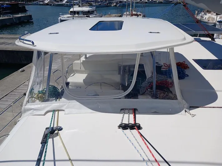 Andiamo IV Yacht Photos Pics Leopard 48 catamaran, 2018 model, docked with visible ropes and clear enclosure.
