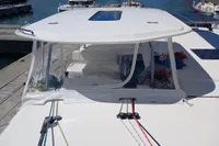 Leopard 48 catamaran, 2018 model, docked with visible ropes and clear enclosure.