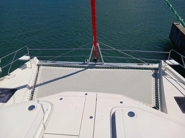 Andiamo IV Yacht Photos Pics Leopard 48 catamaran deck with netting, 2018 model, docked on calm water.