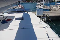 Leopard 48 catamaran docked at marina, showcasing deck and solar panels, 2018 model.