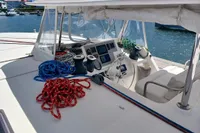 Leopard 48 yacht cockpit with ropes and navigation equipment, docked in a marina, 2018 model.
