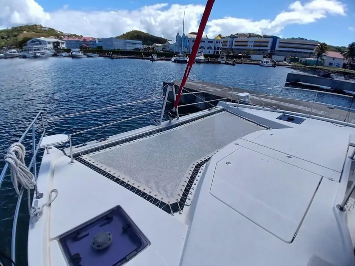 Andiamo IV Yacht Photos Pics Leopard 48 catamaran docked at marina, showcasing spacious deck and netting, 2018 model.