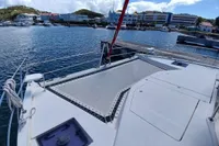 Leopard 48 catamaran docked at marina, showcasing spacious deck and netting, 2018 model.