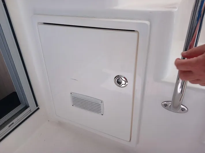 Andiamo IV Yacht Photos Pics Compartment door on a 2018 Leopard 48 yacht with a handrail and lock.