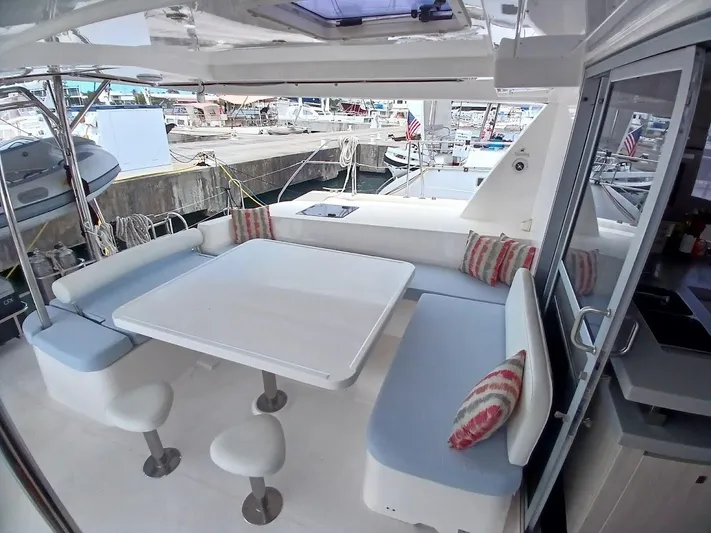 Andiamo IV Yacht Photos Pics Leopard 48 yacht interior with seating area, table, and marina view, 2018 model.