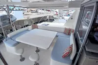 Leopard 48 yacht interior with seating area, table, and marina view, 2018 model.