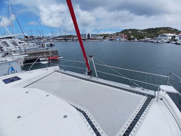 Andiamo IV Yacht Photos Pics Leopard 48 catamaran docked in a marina, showcasing spacious deck and scenic harbor view.