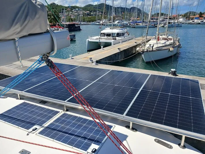 Andiamo IV Yacht Photos Pics 2018 Leopard 48 yacht with solar panels docked at a marina.