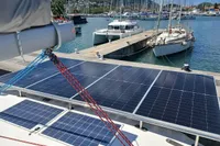 2018 Leopard 48 yacht with solar panels docked at a marina.