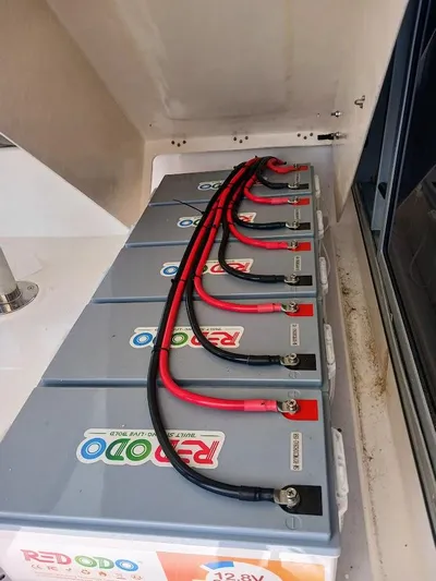 Andiamo IV Yacht Photos Pics Battery setup in a 2018 Leopard 48 yacht, featuring multiple connected batteries.