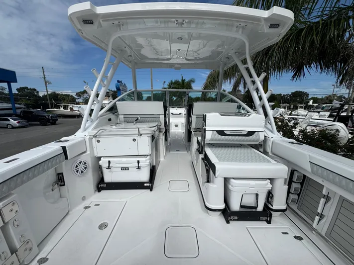  Yacht Photos Pics 2026 Blackfin 302 DC boat interior with seating and storage, under a clear blue sky.