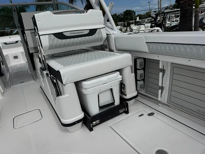  Yacht Photos Pics 2026 Blackfin 302 DC boat interior with cushioned seating and storage compartments.