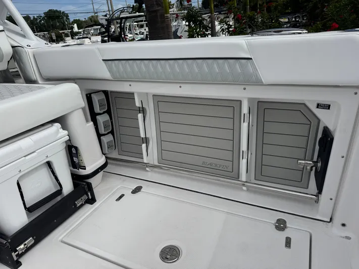 Yacht Photos Pics 2026 Blackfin 302 DC boat interior with storage compartments and cooler.