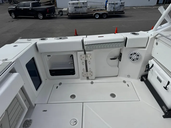  Yacht Photos Pics 2026 Blackfin 302 DC boat deck with storage compartments and seating area.