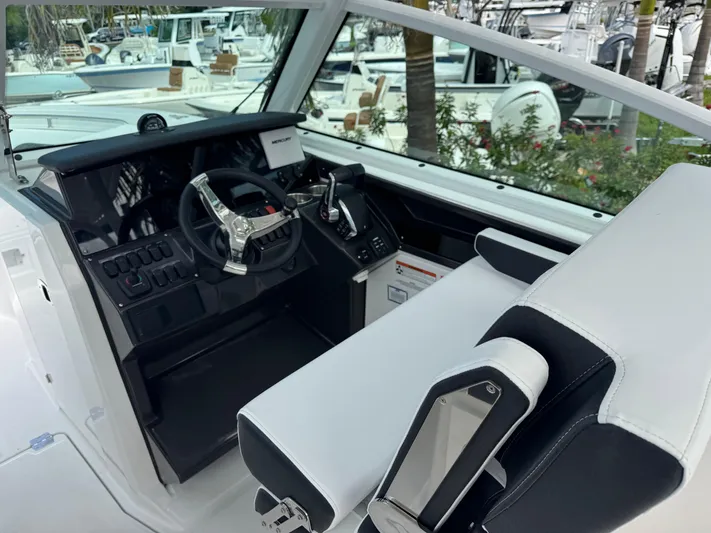  Yacht Photos Pics Interior view of 2026 Blackfin 302 DC boat cockpit with modern steering and controls.
