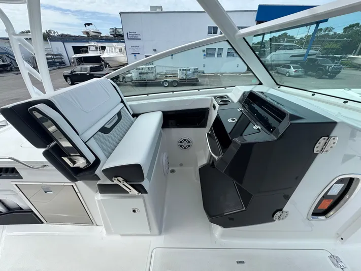  Yacht Photos Pics 2026 Blackfin 302 DC boat interior with modern seating and control panel.