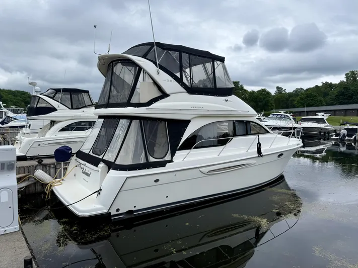  Yacht Photos Pics 2004 Meridian 381 Sedan yacht docked at marina under cloudy sky.
