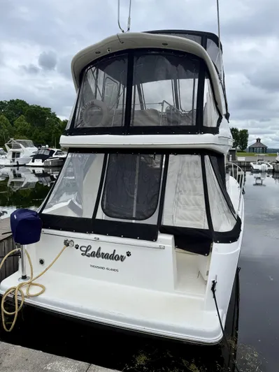  Yacht Photos Pics 2004 Meridian 381 Sedan boat docked at marina, featuring enclosed upper deck.