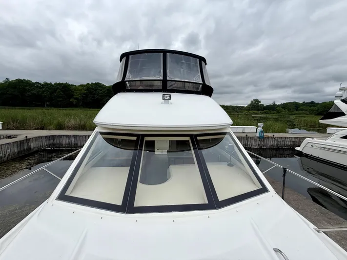  Yacht Photos Pics 2004 Meridian 381 Sedan yacht docked under cloudy skies.