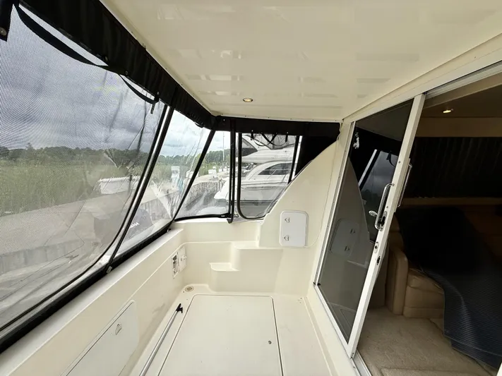  Yacht Photos Pics 2004 Meridian 381 Sedan yacht interior with sliding glass door and covered seating area.