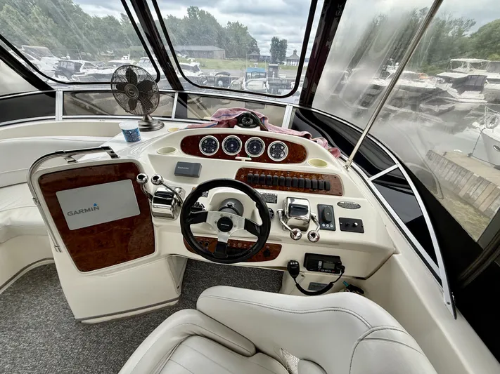  Yacht Photos Pics Helm of 2004 Meridian 381 Sedan with Garmin navigation, steering wheel, and control panel.