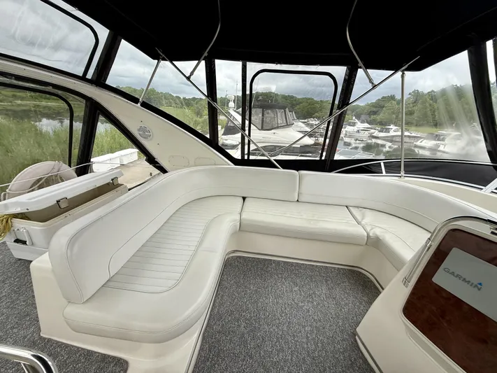  Yacht Photos Pics Interior of 2004 Meridian 381 Sedan yacht with white seating and marina view.