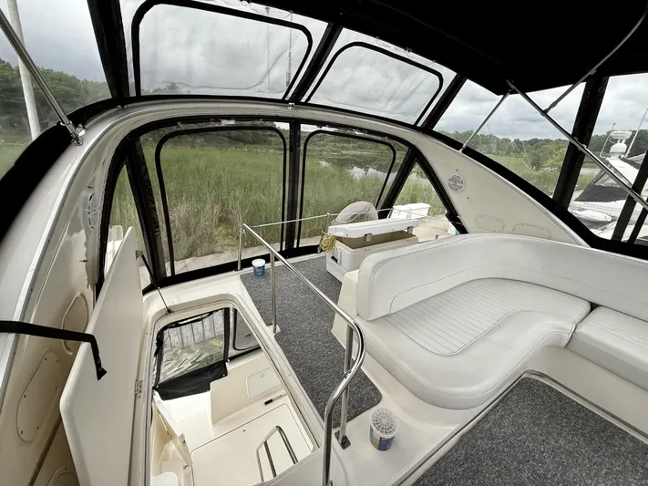  Yacht Photos Pics Interior view of 2004 Meridian 381 Sedan yacht with white seating and panoramic windows.