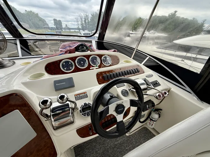  Yacht Photos Pics 2004 Meridian 381 Sedan boat helm with steering wheel, gauges, and controls.