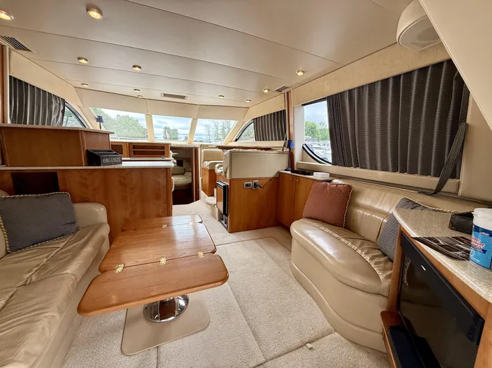  Yacht Photos Pics Luxurious interior of a 2004 Meridian 381 Sedan yacht with plush seating and wooden accents.