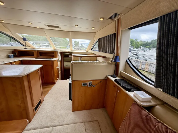  Yacht Photos Pics Luxurious interior of a 2004 Meridian 381 Sedan yacht with wood cabinetry and large windows.