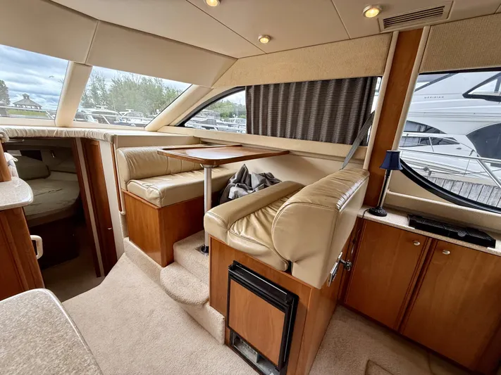  Yacht Photos Pics Interior of 2004 Meridian 381 Sedan yacht with beige seating and wooden cabinetry.