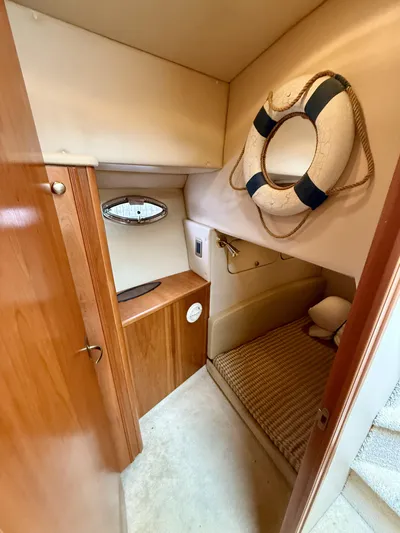  Yacht Photos Pics 2004 Meridian 381 Sedan cabin interior with life preserver and wooden accents.