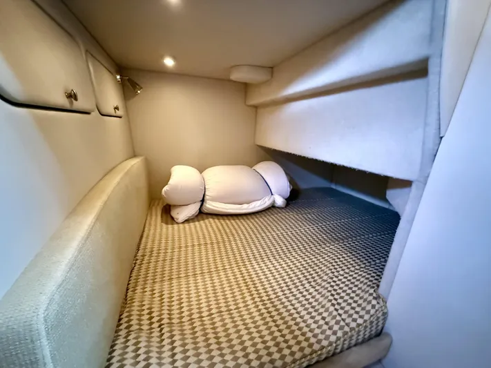  Yacht Photos Pics Cozy cabin interior of 2004 Meridian 381 Sedan with cushioned bed and soft lighting.